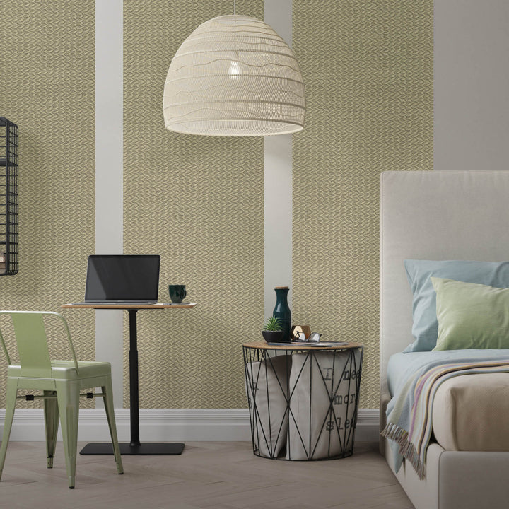 Modern bedroom with a bed, chair, table, and lamp against a patterned wall.