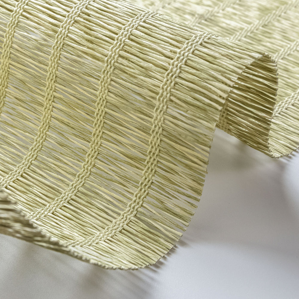 Close-up of a textured green fabric with a white background