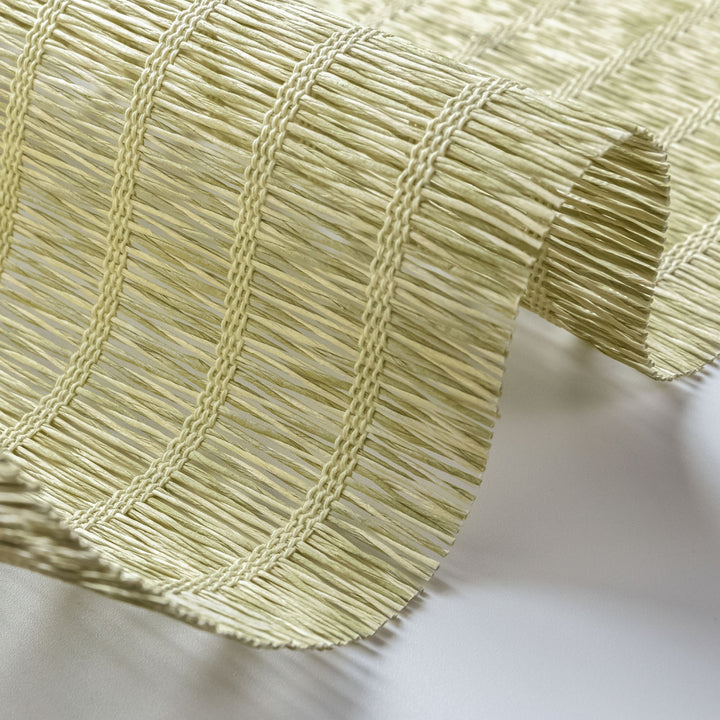 Close-up of a textured green fabric with a white background