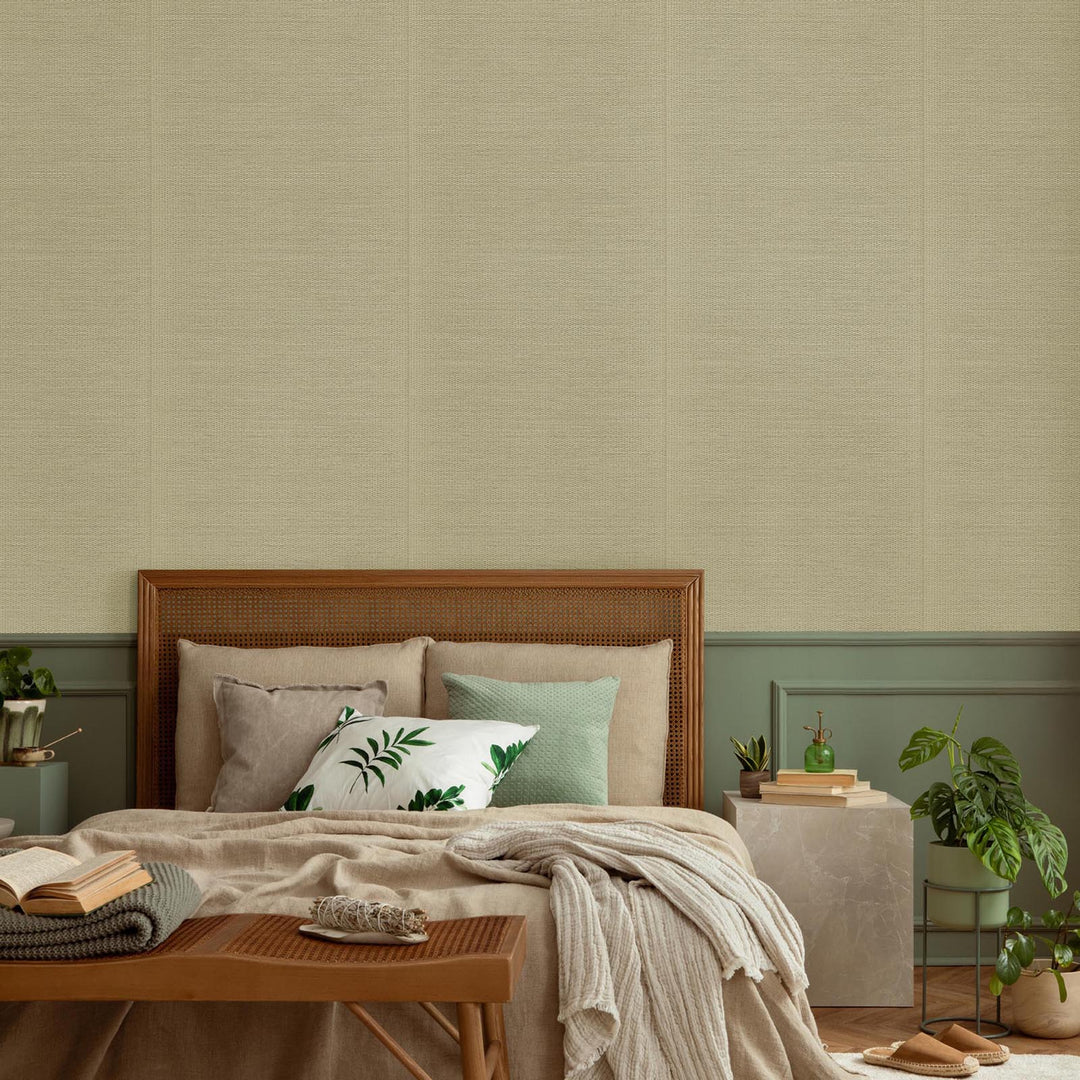 Bedroom with wooden headboard, pillows, and a green wall.