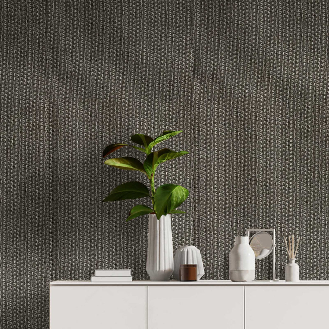 Modern interior with a plant and decorative items against a textured wall.