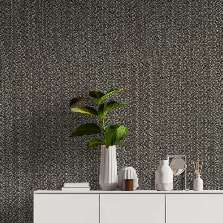 Modern interior with a plant and decorative items against a textured wall.