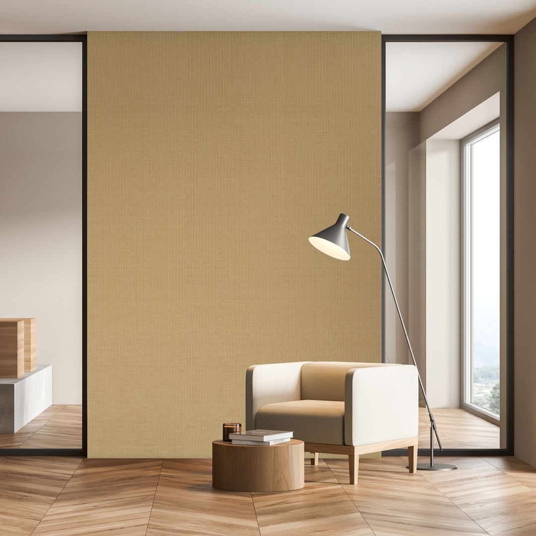 Modern interior with a beige armchair, small table, and floor lamp against a yellow wall.