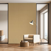 Modern interior with a beige armchair, small table, and floor lamp against a yellow wall.