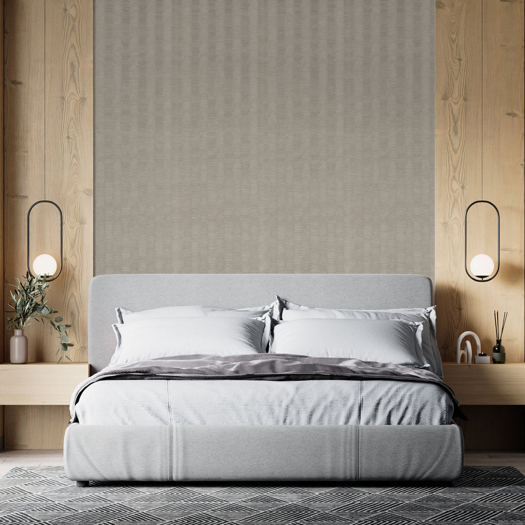 Modern bedroom with a gray bed against a wooden wall.