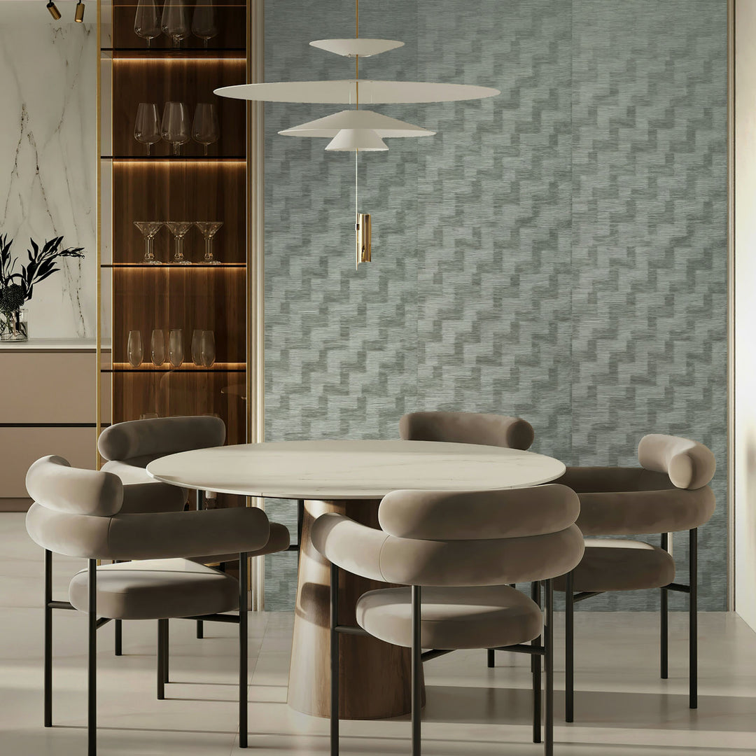 Modern dining room with a round table and chairs against a textured wall.