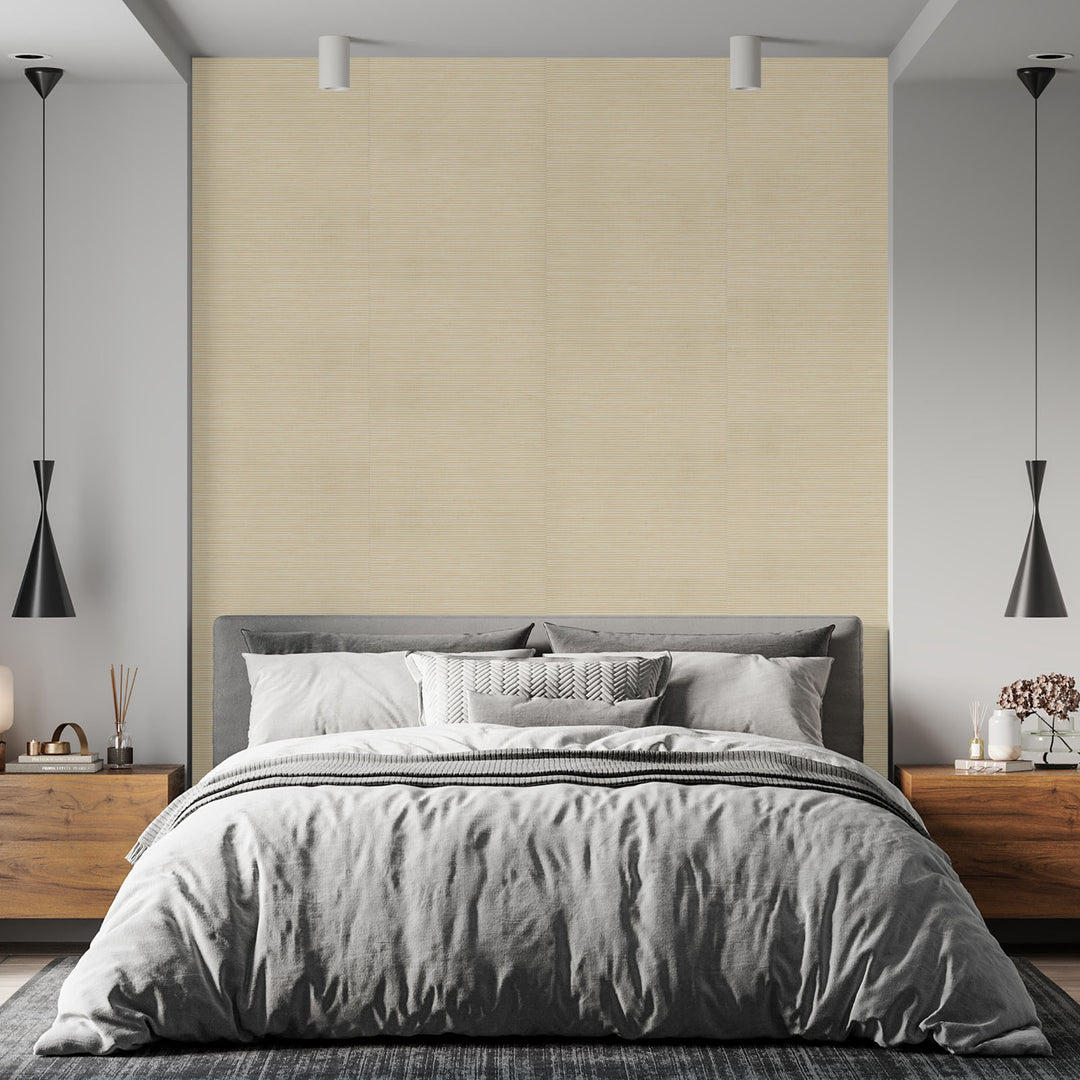 Modern bedroom with gray bedding and wooden furniture.