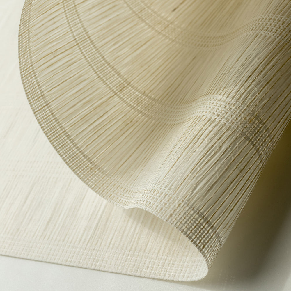 GoDear_Design_Close-up of a textured beige fabric with a subtle pattern on a light background