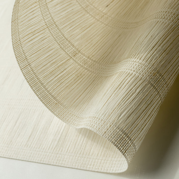 GoDear_Design_Close-up of a textured beige fabric with a subtle pattern on a light background