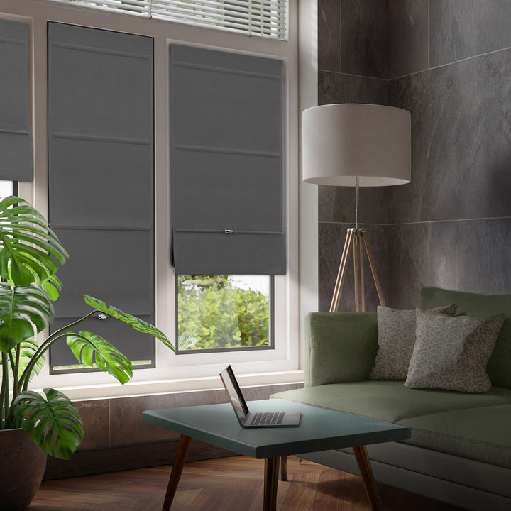 GoDear Design Modern living room with gray roller blinds, a green sofa, and a lamp.