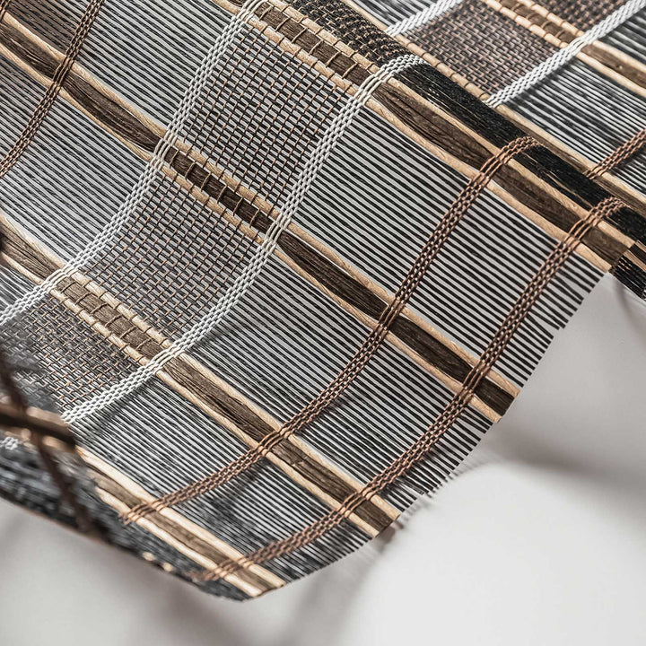 Close-up of woven fabric with brown and gray stripes on a white background
