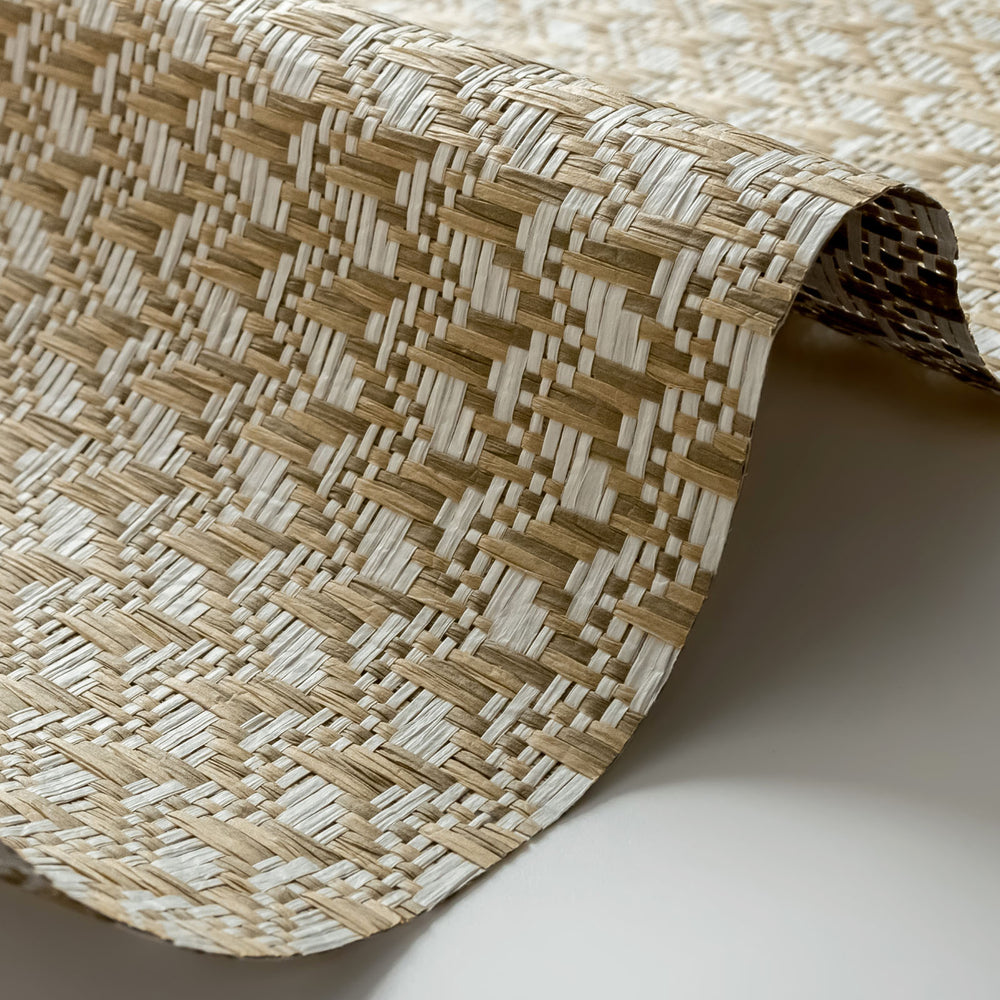 Close-up of a woven mat with a geometric pattern on a neutral background