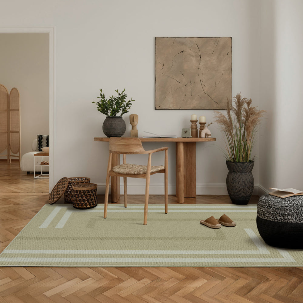Modern interior with a wooden dining table, chairs, and decorative elements on a light green rug.