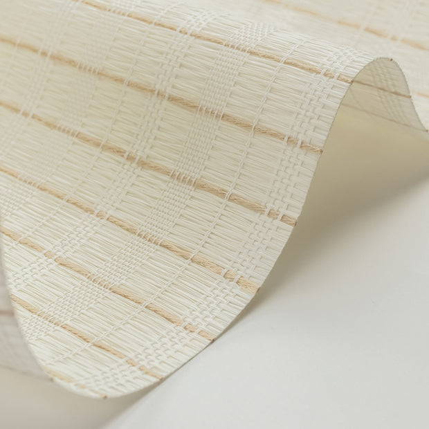 Close-up of a textured beige paper roll on a light background