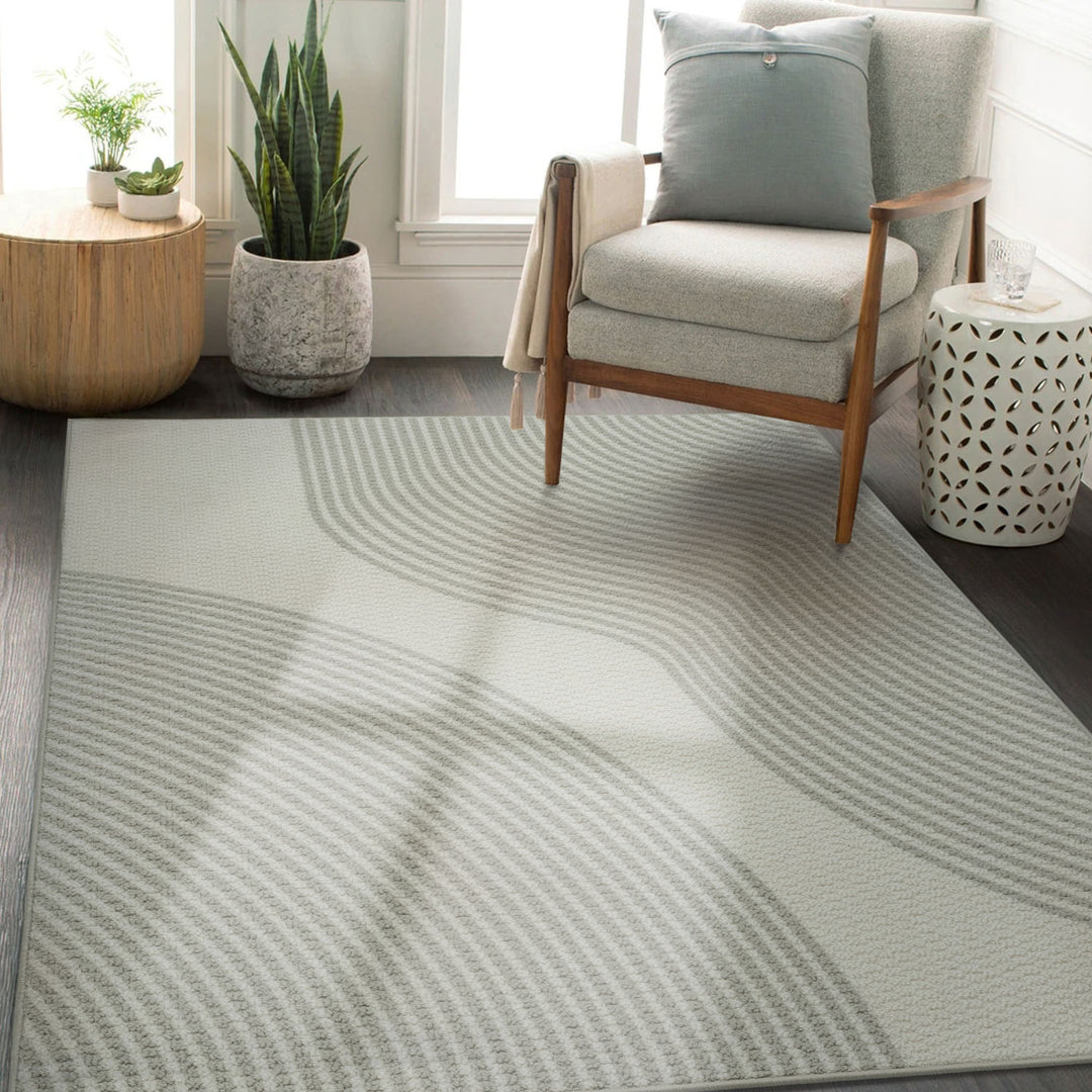 Living room with a patterned rug, armchair, and decorative items.