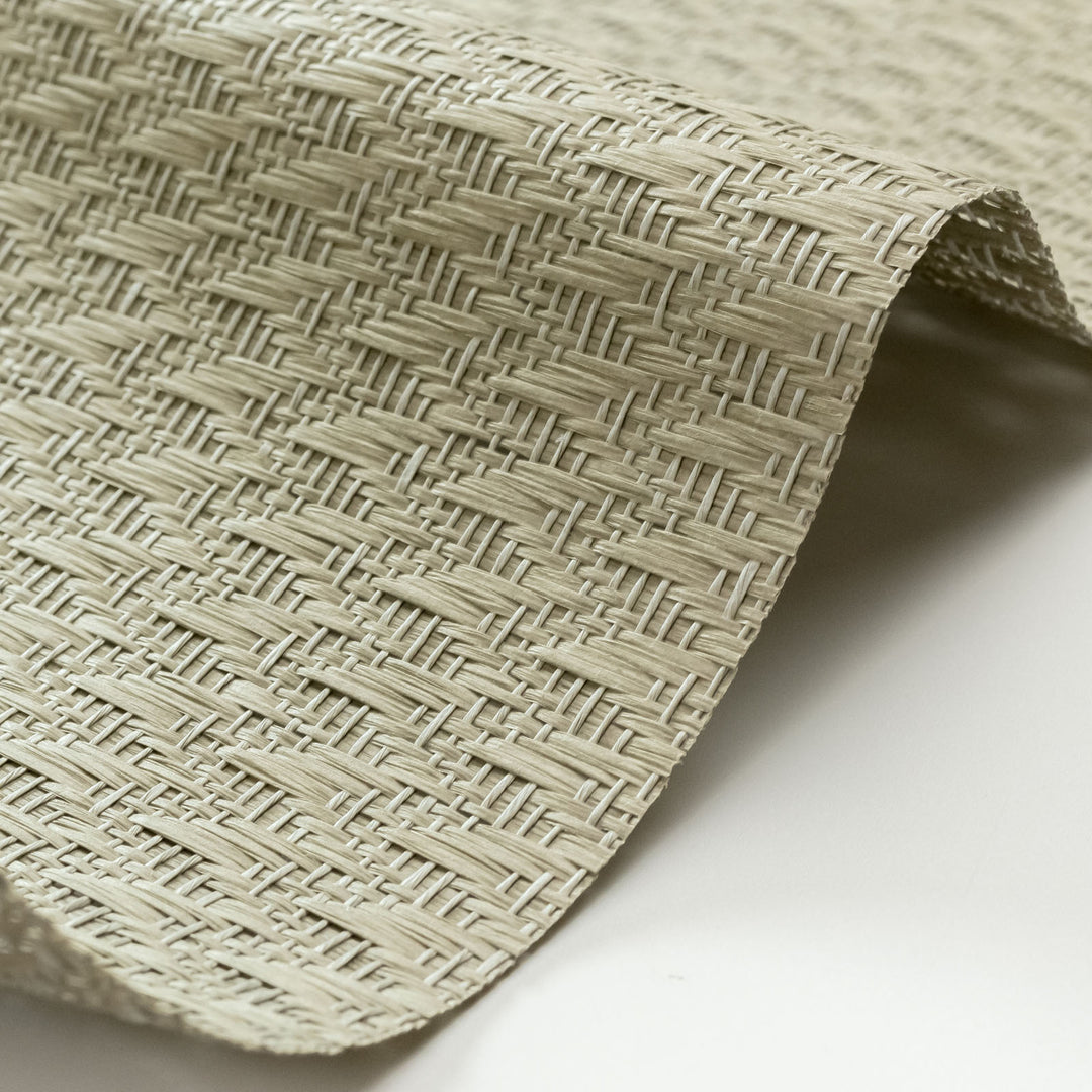Close-up of woven beige mat on a white background