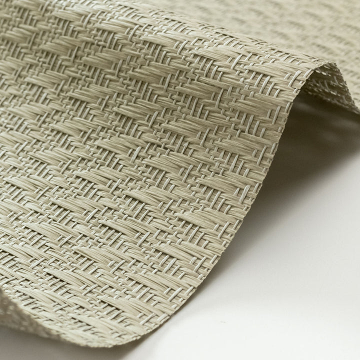 Close-up of woven beige mat on a white background