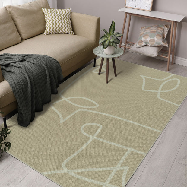 Living room with a beige sofa, patterned cushions, and a green rug with white abstract design.