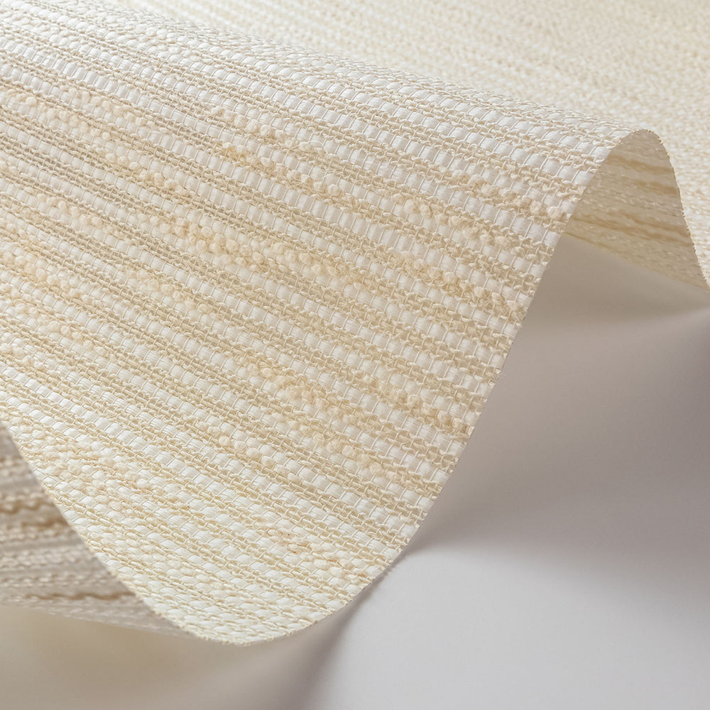 Close-up of beige woven fabric on a light background
