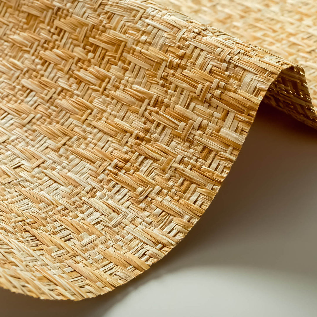 Close-up of woven wallpaper fabric with golden and beige interlaced fibers, highlighting natural textured surface and intricate weave pattern.