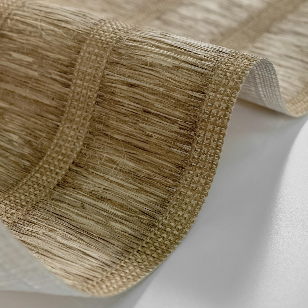 Close-up of natural woven wallpaper with textured brown fibers and vertical stripe detail, showcasing rustic and organic design.