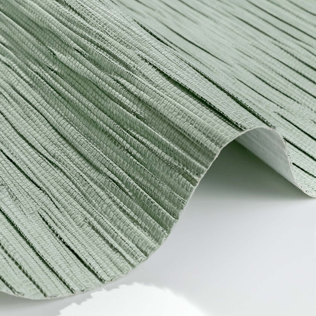 Close-up of textured green woven material with raised ridges and natural fiber look.