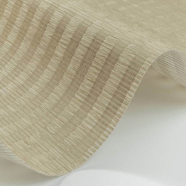 Close-up of beige pleated woven material with subtle stripe texture and natural fiber appearance.