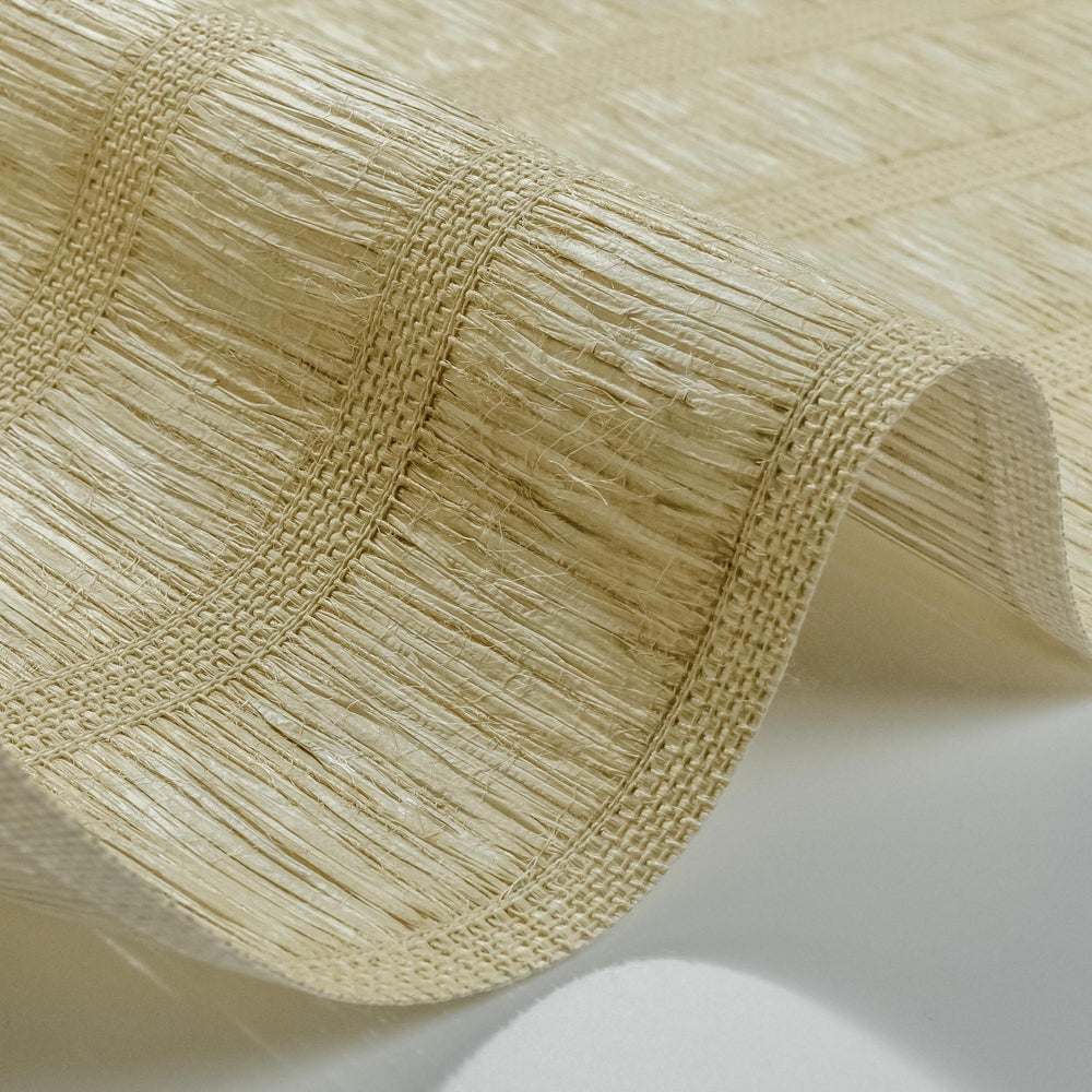 Close-up of light beige woven wallpaper with natural fiber texture and vertical stripe detail.