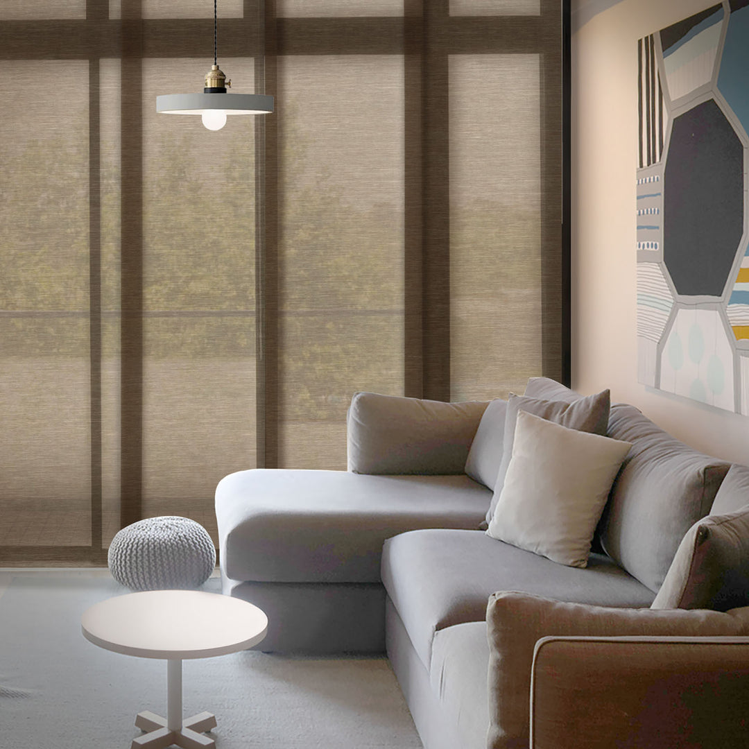 GoDear Design_Modern living room with a gray sectional sofa, round coffee table, and abstract wall art.