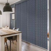 GoDear Design Dining room with a textured blue wall panel and wooden table.