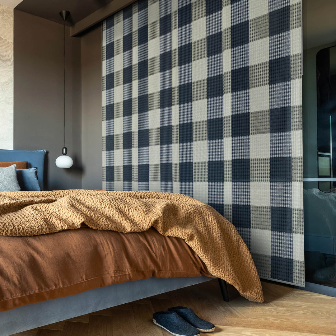 GoDear Design Bedroom with plaid wall, brown bedspread, and blue slippers on wooden floor.