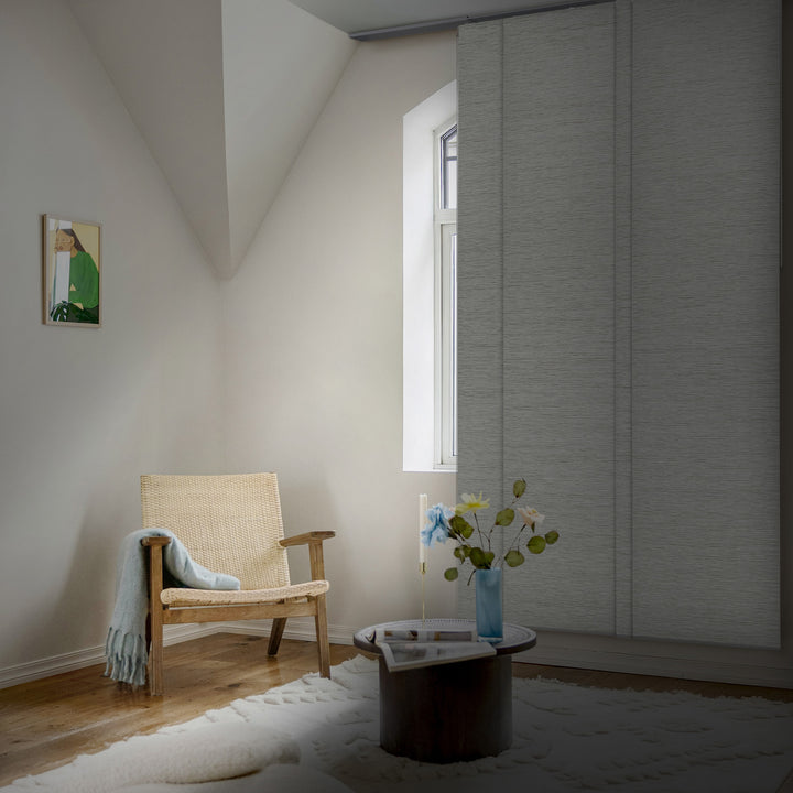 Cozy room with a wooden armchair, small table, and window.