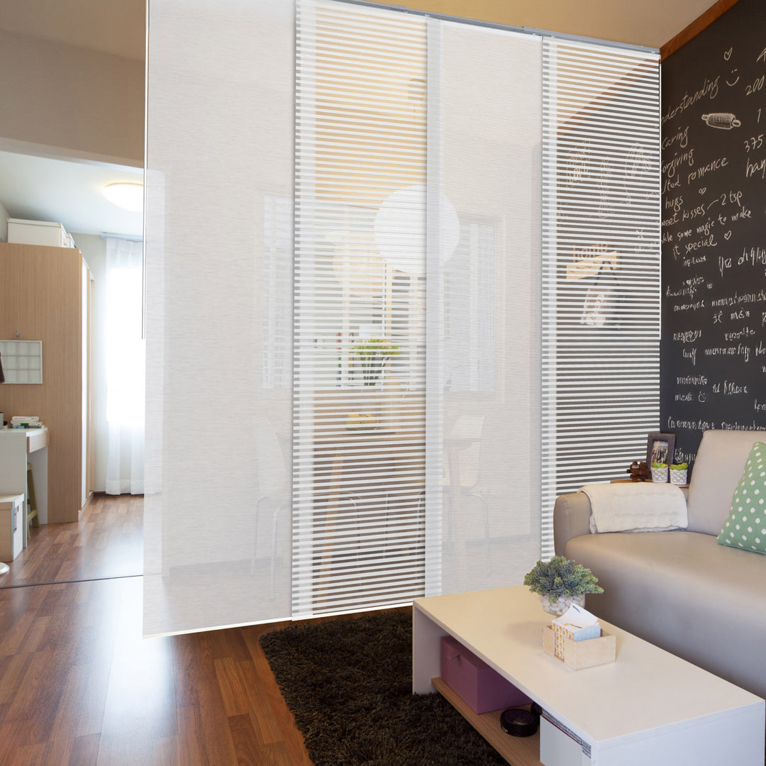 Modern living room with a glass partition, sofa, and coffee table.