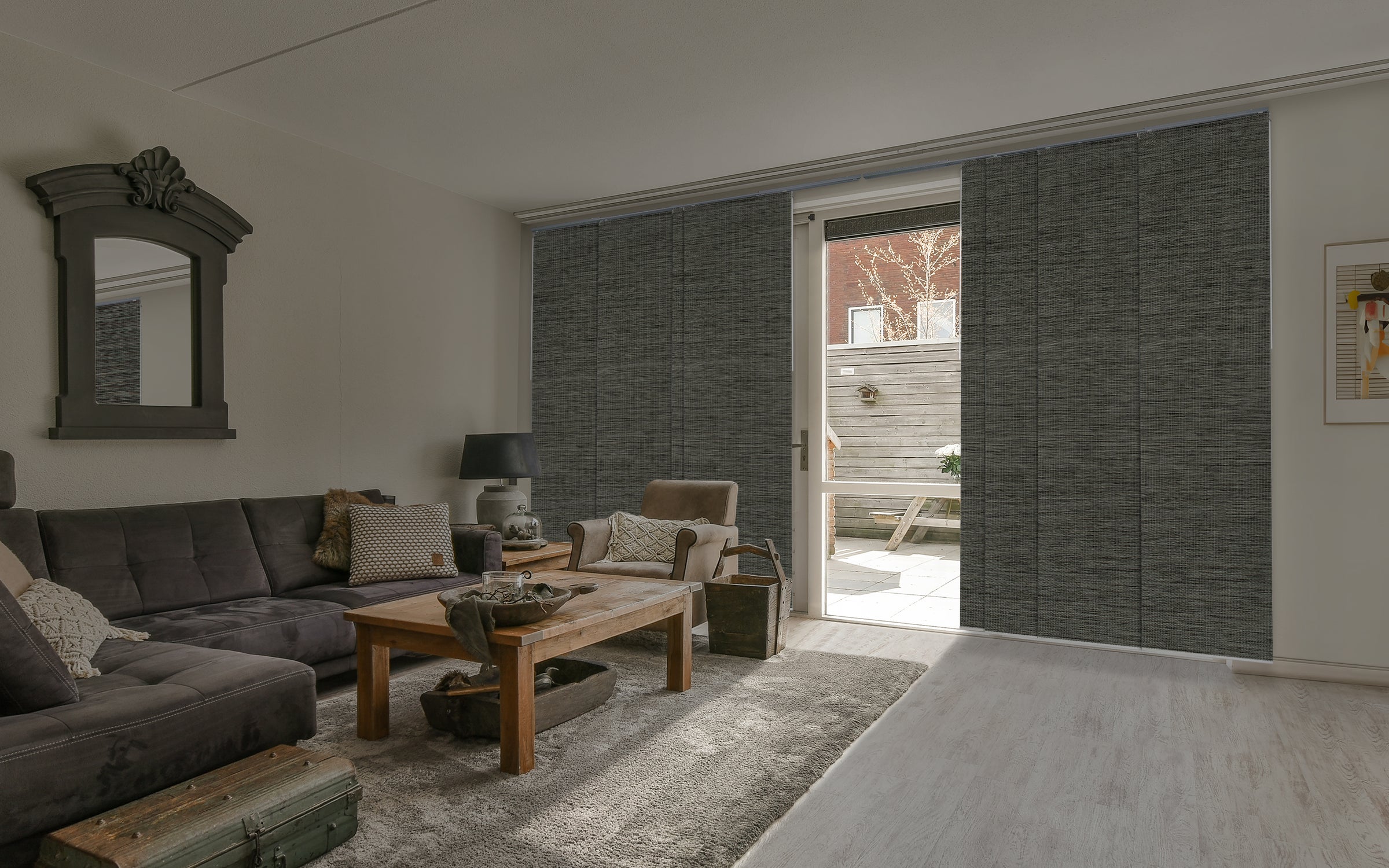 GoDear Design_Living room with gray sofa, wooden coffee table, and open door leading to outdoor area.
