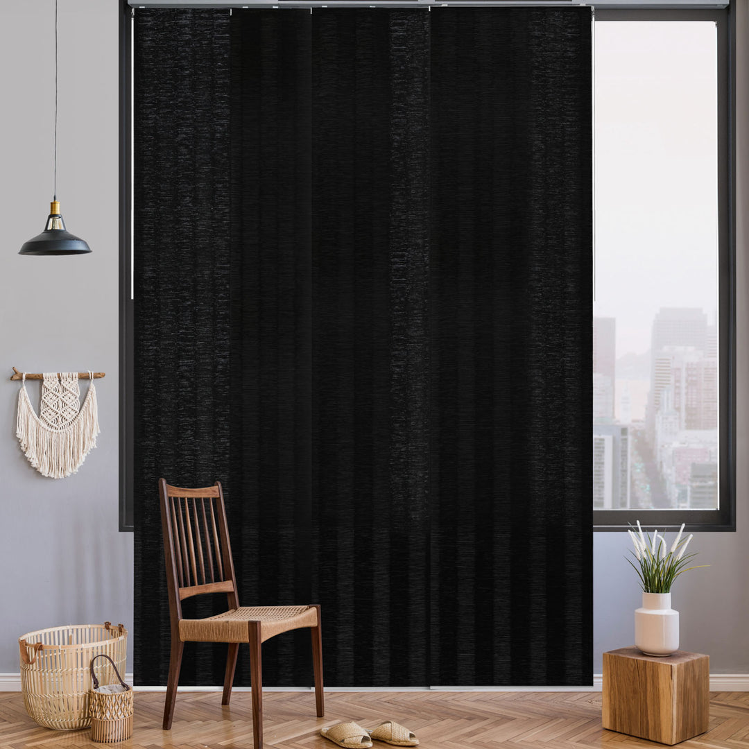 GoDear Design Black curtain in a room with a chair, basket, and small plant.
