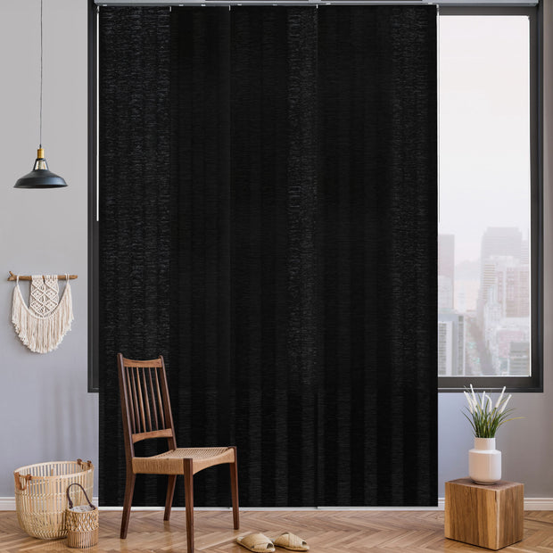 GoDear Design Black curtain in a room with a chair, basket, and small plant.