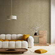 Minimalist living room with a cream tufted sofa, mustard accents, a wooden side table, and a warm beige textured wall.