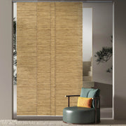 GoDear Woven blind covering a sliding glass door with a chair and cushions in the foreground.