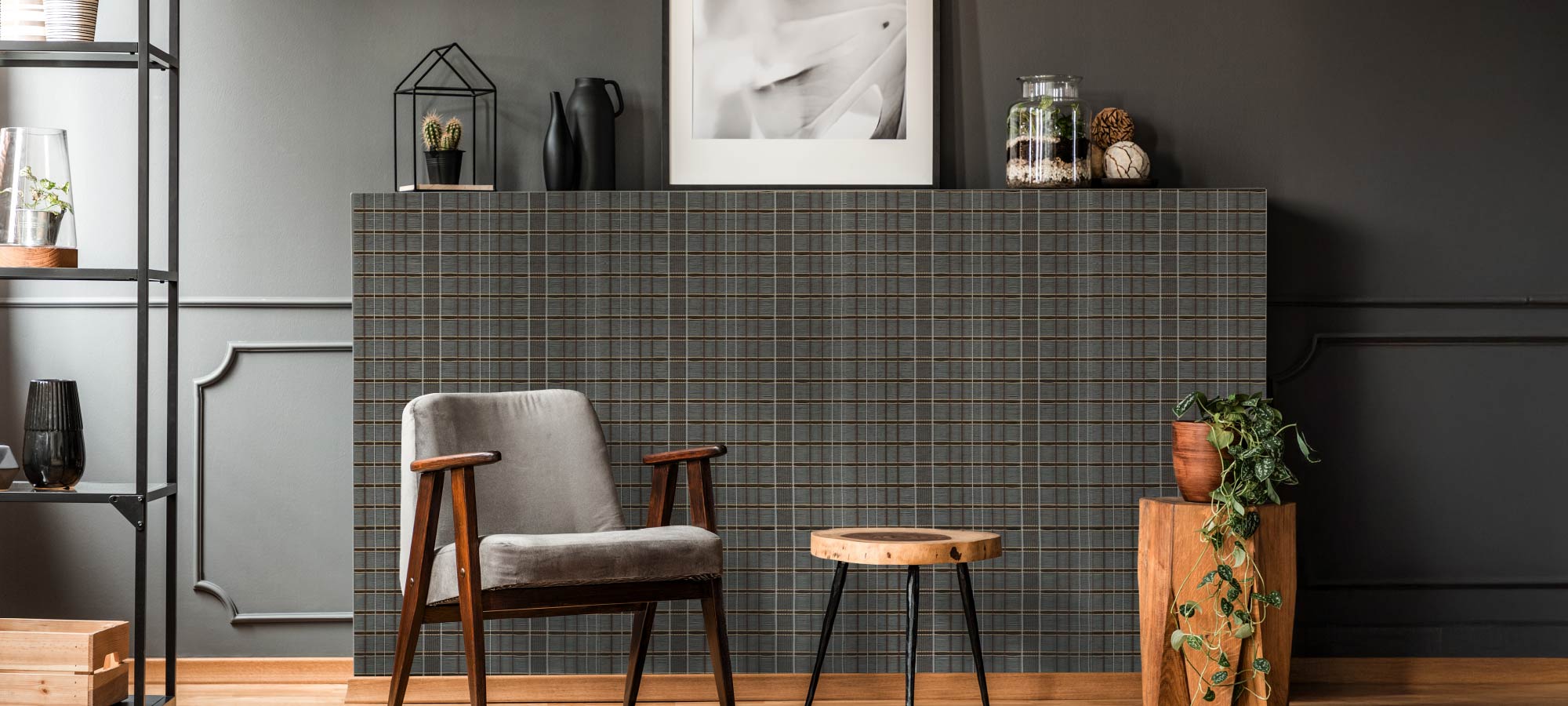 Modern interior with dark gray plaid wallpaper, mid-century armchair, wooden side table, indoor plants, and minimalist décor accents.