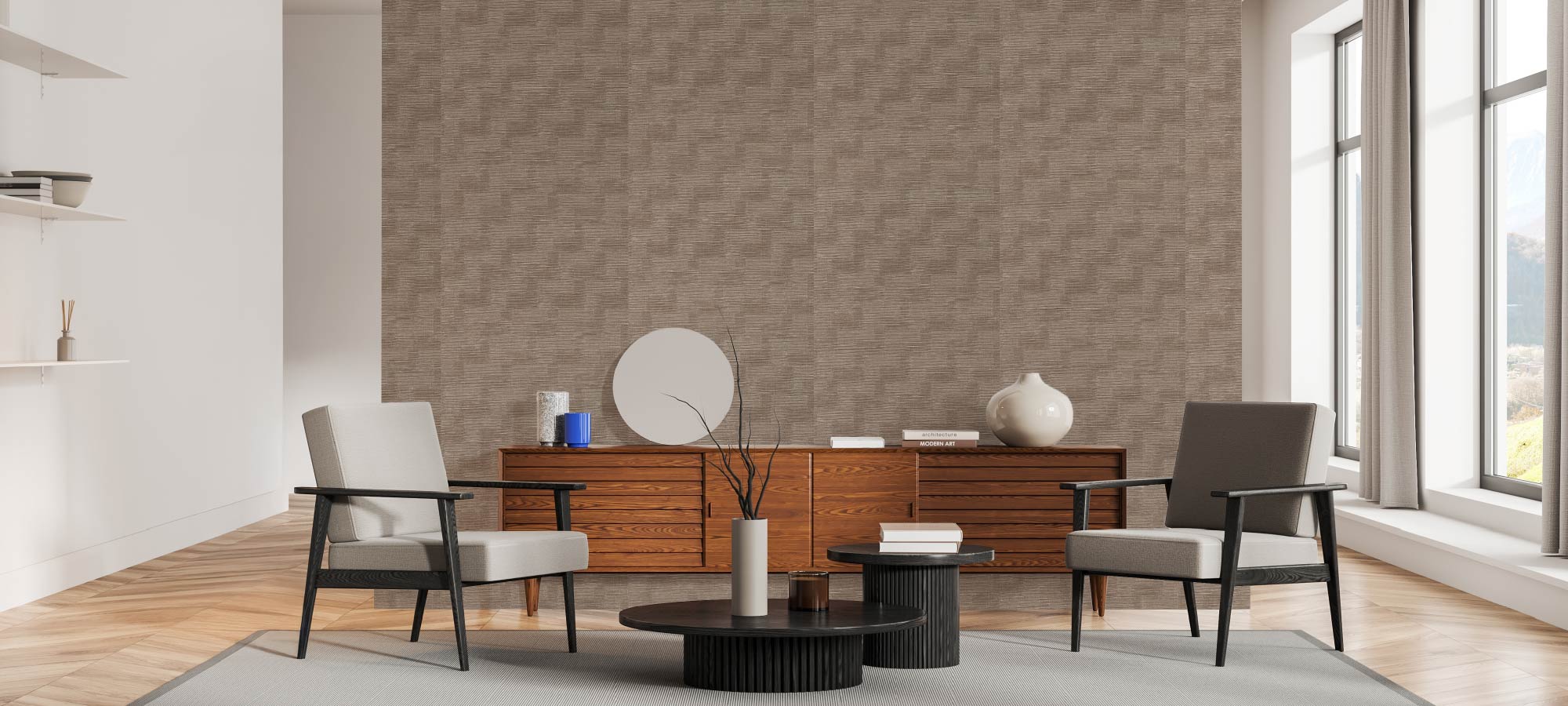 Minimalist living room with brown textured accent wall, wooden sideboard, modern armchairs, round coffee tables, large windows with curtains, and decorative vases.
