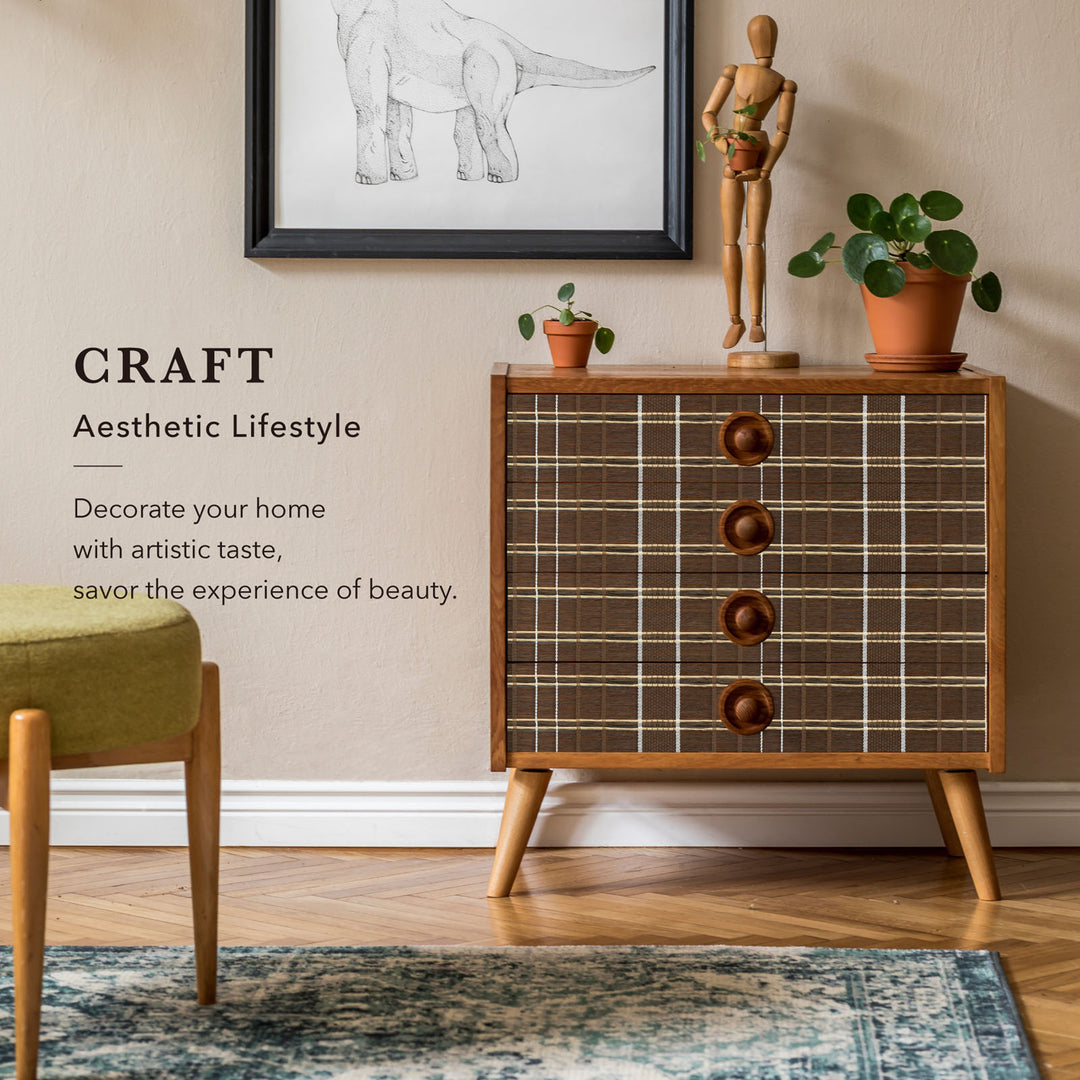 Wooden dresser with plaid pattern and wooden knobs in a room with decor elements.