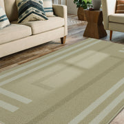 Green striped rug in a living room setting with a beige sofa and wooden coffee table.