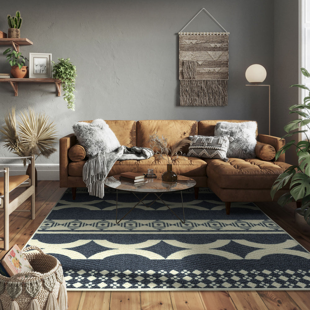 Living room with brown sectional sofa, patterned rug, and decorative elements.