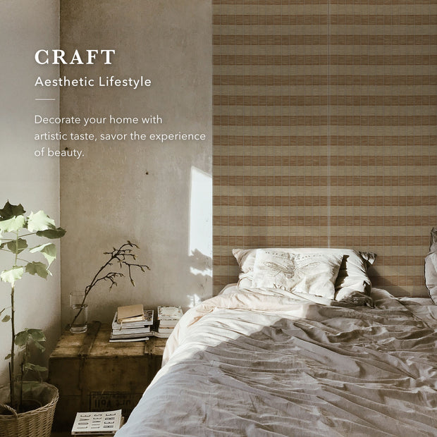 Bedroom with striped wallpaper, plant, and books on a nightstand.