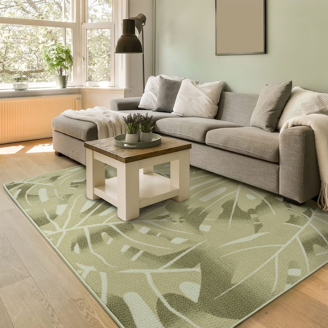 Living room with a gray sectional sofa, wooden coffee table, and green patterned rug.