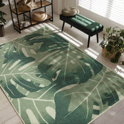 Green leaf-patterned rug in a room with a bench and plants