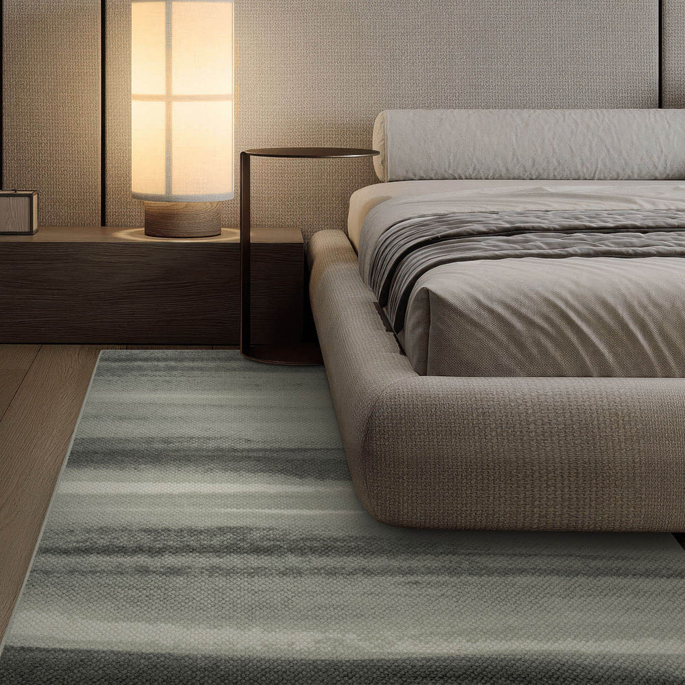 Modern bedroom with a bed, nightstand, and striped rug.