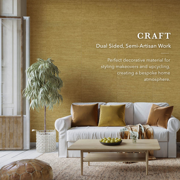 Living room with a white sofa, wooden coffee table, and decorative elements against a textured yellow wall.
