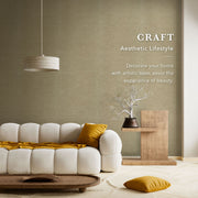 Modern living room with a white sofa, yellow cushions, and a wooden side table against a textured wall.