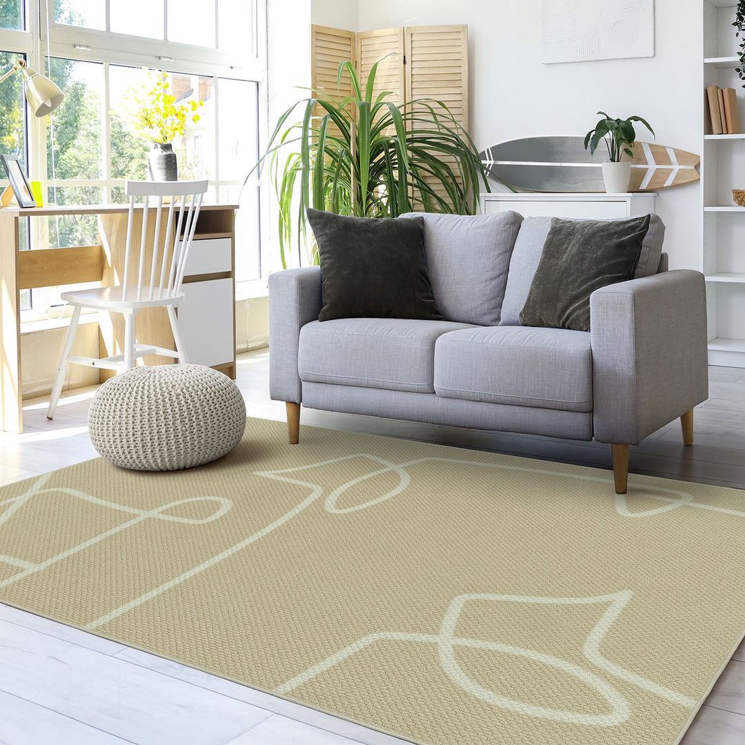 GoDear Design_Gray sofa with decorative pillows on a beige rug in a living room setting.